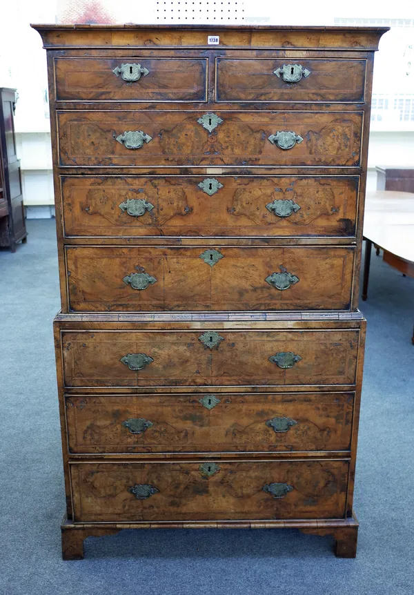 A George I featherbanded figured walnut chest on chest of two short over six long graduated drawers on bracket feet, 104cm wide x 177cm high x 50cm de