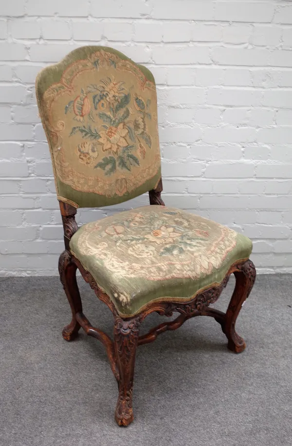 A 17th century Continental walnut side chair with serpentine seat on carved cabriole supports, 60cm wide x 105cm high.