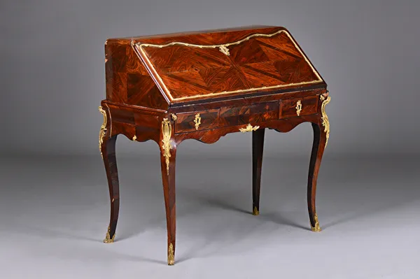 A 19th century French ormolu mounted rosewood bureau on stand, the shaped fall enclosing a fitted interior, the stand with two frieze drawers on cabri