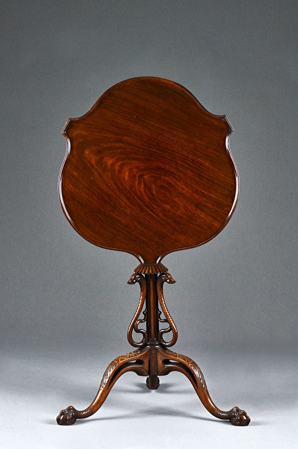A Victorian mahogany occasional table, the shaped snap-top on a fluted column mounted with three opposing serpents on tripod base resting on scale car