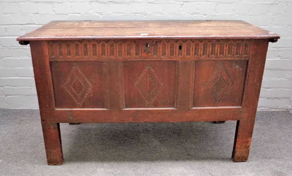 A 17th century oak coffer, the twin plank top over triple panel front on high stile feet, 122cm wide x 73cm high x 48cm deep.
