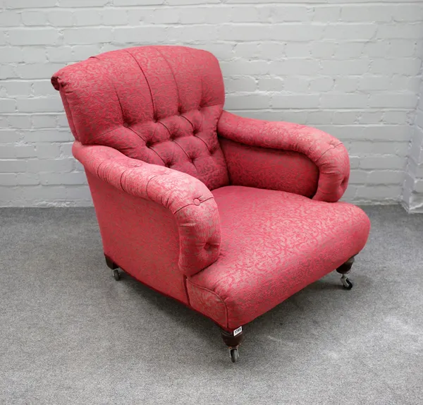 A mid Victorian easy armchair with button back and over stuffed arms on turned supports, 78cm wide x 84cm high.