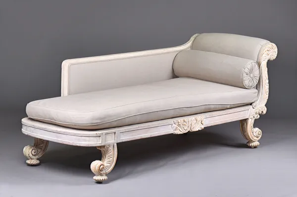 A Victorian carved beech day bed, later gilded and white washed with single rollover end on carved scrolled supports and compressed melon feet, 195cm