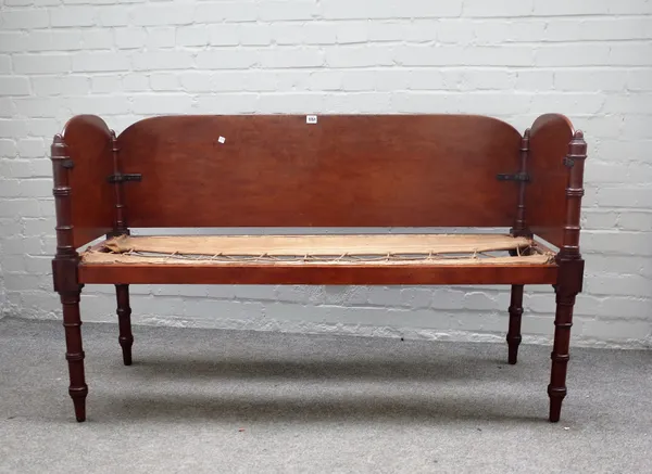 An early 19th century mahogany campaign sofa on ring turned supports, 136cm wide x 82cm high x 53cm deep.  Provenance, Removed from Norris Castle, Isl