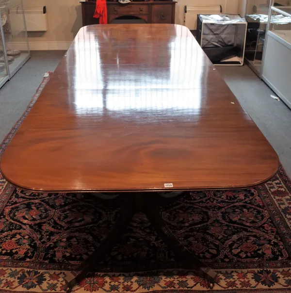 A George III and later mahogany D-end extending dining table on eight downswept supports with two extra leaves, 122cm wide x 203cm long x 305cm long e