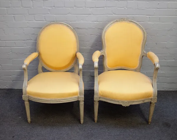 A Louis XVI style open arm fauteuil, with cream painted frame, on tapering fluted supports, together with another similar, 61cm wide x 100cm high.