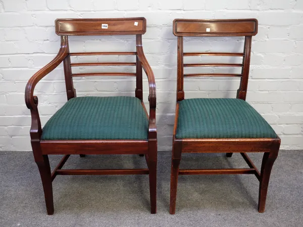 A set of eight George III mahogany dining chairs, each with triple waist rail on shallow sabre supports including a pair of carvers, (8).