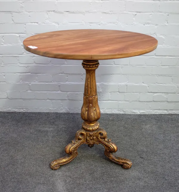 A Victorian carved giltwood tripod table, the base with fluted and reeded baluster column and three downswept supports, the later circular mahogany to