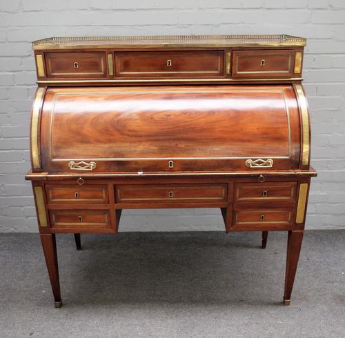 A 19th century French brass mounted mahogany cylinder bureau, the marble top with a three drawer superstructure over fitted interior and four frieze d