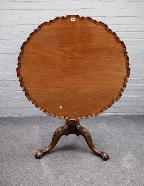 A large George III mahogany tripod occasional table, the pie crust snap top on birdcage mount, carved base and ball and claw feet, 90cm diameter x 73c