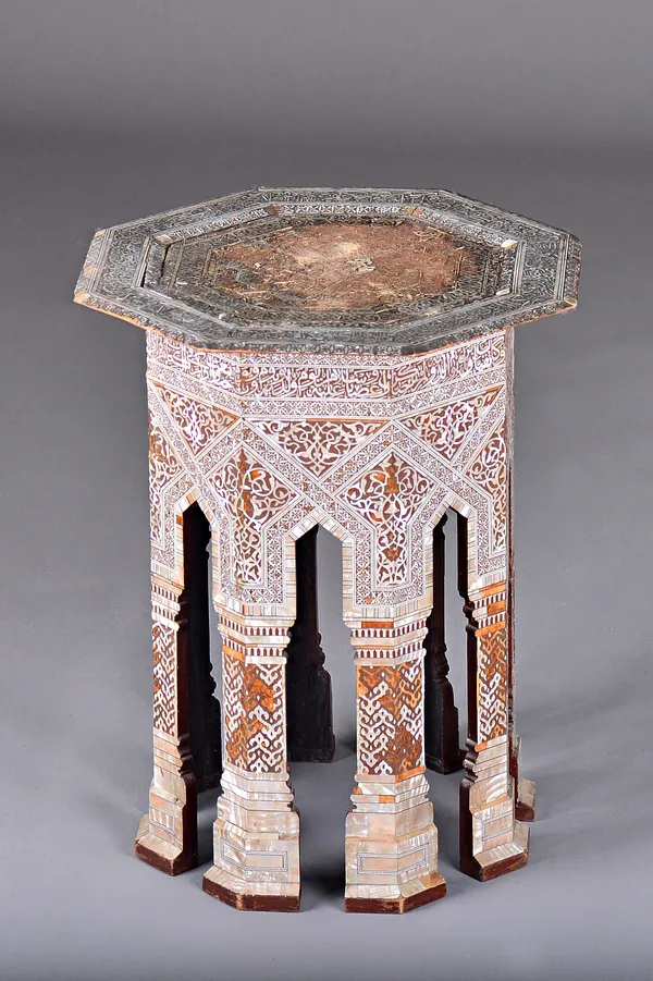 An early 20th century Moorish octagonal occasional table profusely inlaid with mother-of-pearl, 47cm wide x 59cm high. Illustrated.