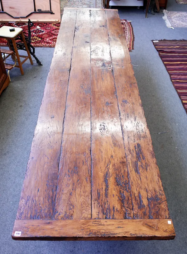 A 17th century style oak refectory table, the cleated plank top on six turned supports united by perimeter stretcher, 84cm wide x 369cm long x 77cm hi