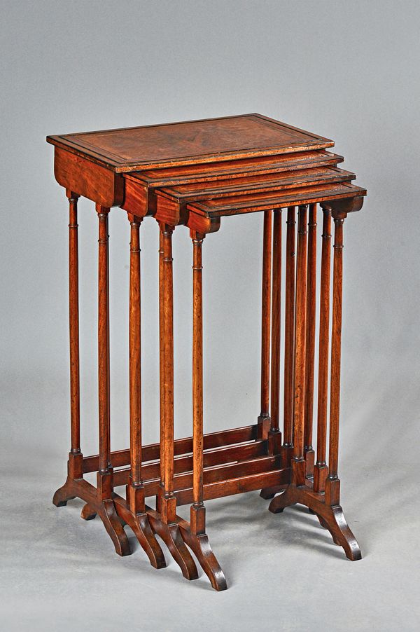 A nest of four Regency amboyna and padouk occasional tables on turned supports, the larger 47cm wide x 77cm high x 29cm deep. Illustrated.