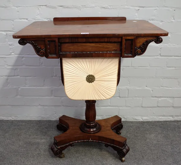 A George IV rosewood work table, the angle adjustable top over single drawer and pull out wool box on quatrefoil platform and four scroll feet, 66cm w