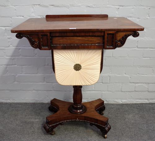 A George IV rosewood work table, the angle adjustable top over single drawer and pull out wool box on quatrefoil platform and four scroll feet, 66cm w