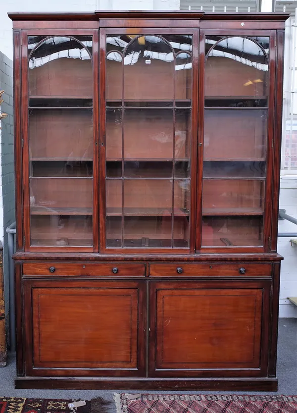 James Winter, 101 Wardour Street, an early 19th century mahogany breakfront bookcase, the astragal glazed doors over pair of drawers and cupboards on