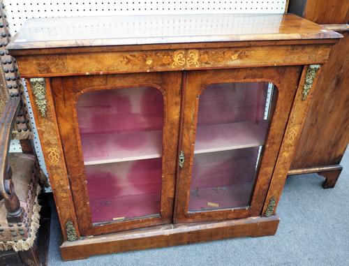 A Victorian marquetry inlaid figured walnut pier cabinet with pair of glazed doors on plinth base, 112cm wide x 107cm high x 33cm deep.