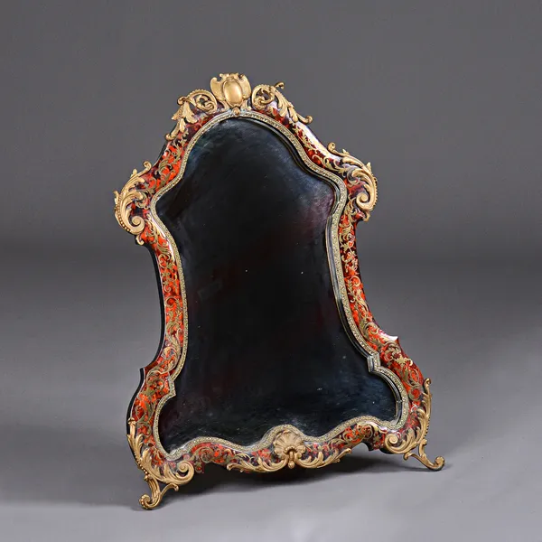 A 19th century French ormolu mounted boulle work strut back dressing mirror, of shaped outline, 62cm wide x 80cm high. Illustrated.