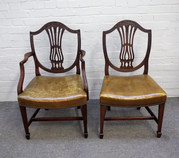 A set of ten George III style mahogany shield back dining chairs on tapering square supports, to include a pair of carvers, (10).