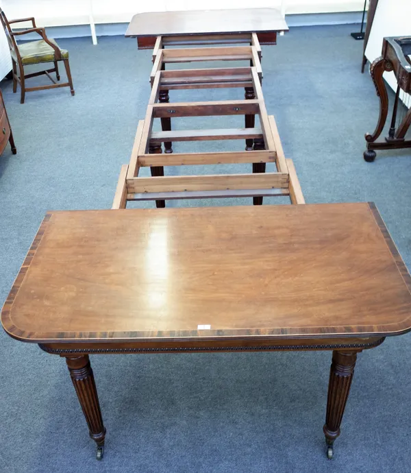 A William IV coromandel banded mahogany extending dining table on eight tapering reeded supports, with five extra leaves, 137cm wide x 148cm long x 43