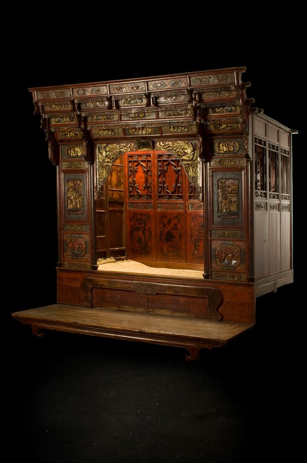 A late 19th/early 20th century red lacquer and parcel gilt opium bed, the stepped cornice above arched top opening, relief carved with extoic birds, t
