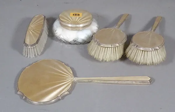 A silver and enamel five piece dressing table set, comprising a clothes brush, two hair brushes, a hand mirror and comb, (a.f.).   CAB