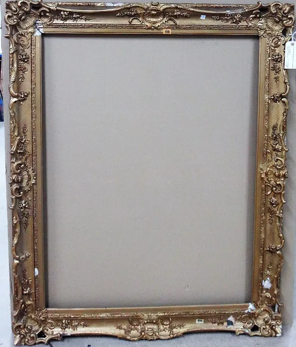 A 19th century gilt plaster swept frame, aperture 116cm x 90cm.   EXTRA
