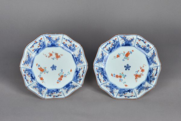 A pair of Japanese kakiemon style dishes, Edo period, 18th/19th century, each painted in underglaze-blue, enamels and gilding, in the centre with flow