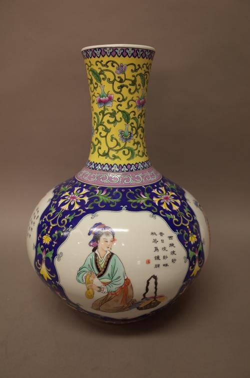 A large Chinese famille-rose bottle vase, 20th century, painted with four panels of young women beside lines of script, against  blue and yellow groun