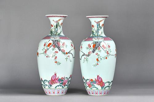 A good pair of Chinese famille-rose vases, 19th century,each ovoid body finely enamelled with two carp amongst foaming waves beneath overhanging branc