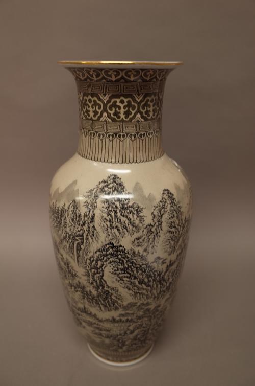 A Chinese porcelain baluster vase, 20th century, painted in tones of grey with a mountainous landscape with pavilions against a light brown ground, ir