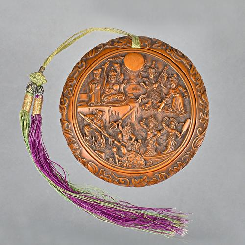 A Chinese circular shallow wood box and cover, 19th century, the cover well carved with a figurative panel, the box carved with flowers and insects an