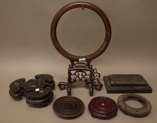 A quantity of Chinese stands, mostly hardwood, of various forms; also a wooden lamp stand, (a.f), (approx. 50)This lot is subject to VAT on the hammer