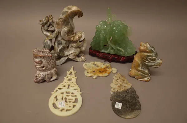 A group of Chinese archaistic jade and hardstone carvings, comprising; a dragon libation cup, 19.5cm. high; two pig dragons; a dragon and chilong; two