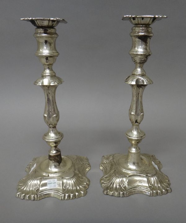 Two similar silver table candlesticks, each with a knopped stem and raised on a shaped square base, with detachable sconces,in an 18th century design,