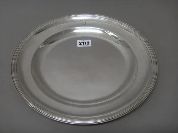 A 19th century French main course plate, of circular form, crest and motto engraved within a reeded rim, diameter 28.5cm, weight 707 gms.