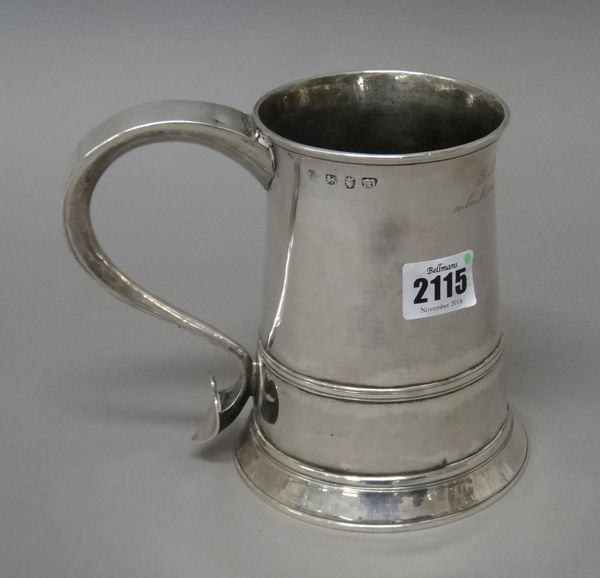 An early George III silver tankard converted for use as a large mug, of tapering cylindrical form, with a scrolling handle, having a heart shaped term