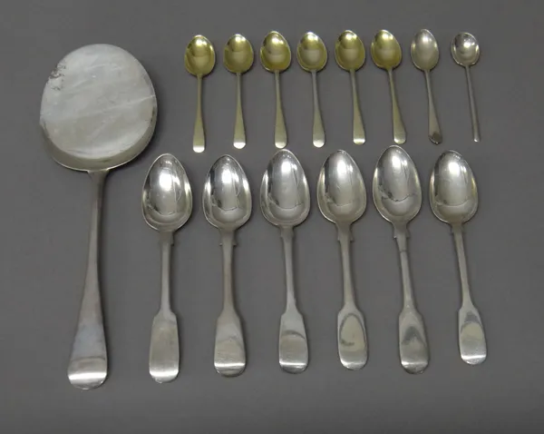 Silver flatware, comprising; six fiddle pattern teaspoons, various dates, a serving slice, London 1909, a set of six gilt coffee spoons, Sheffield 195