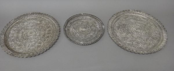 Two similar shaped circular filigree salvers, with stylised scrolled foliate decoration, diameters 30.5cm and 32cm and a shaped circular filigree smal