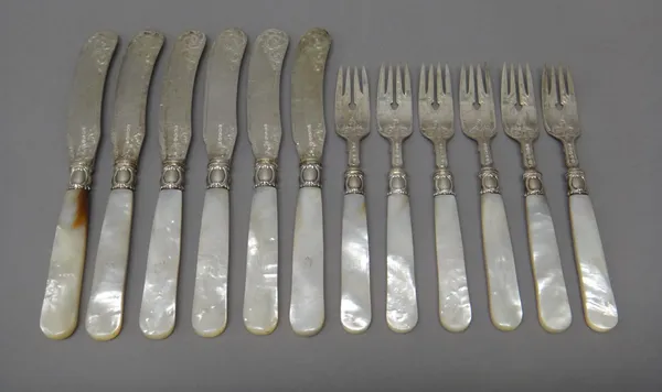 A set of six Victorian pairs of silver dessert or fruit knives and forks, with engraved decoration and with mother-of-pearl handles, Birmingham 1864,