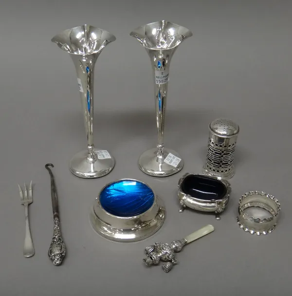 Silver and silver mounted wares, comprising; a pair of trumpet shaped vases, each raised on a circular foot, Birmingham 1904 (loaded), a rattle fitted