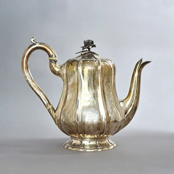 A William IV silver teapot, of ridged baluster form, raised on a shaped circular foot, maker James Charles Edington, London 1831, gross weight 777 gms