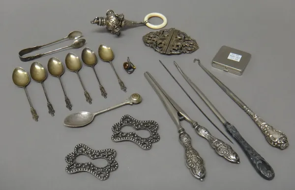 Silver and silver mounted wares, comprising; a Victorian rattle, fitted with five bells, Birmingham 1881, a two piece waist belt buckle, a set of six