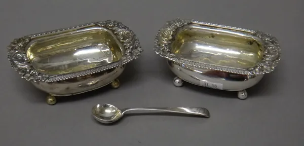 Silver, comprising; a pair of George III curved rectangular salts, each decorated with fruiting vine and scallop shells to the rim, raised on four bal