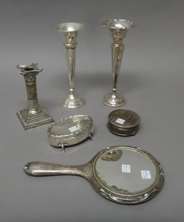 Silver and silver mounted wares, comprising; a Corinthian column candlestick, height 15cm, Sheffield 1911, two vases, an oval hinge lidded trinket box