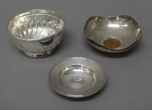 Silver, comprising; a Victorian sugar bowl, with semi-spiral fluted decoration, London 1881, a dish mounted with a George III copper coin, by A.E.Jone