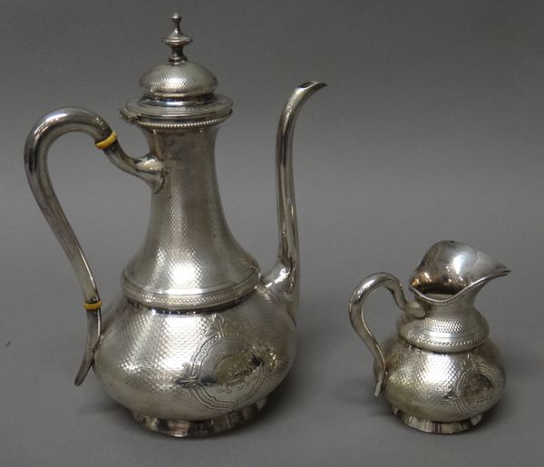 A French coffee pot, with a matching milk jug, each piece of baluster form, with engine turned decoration, monogram engraved within a central cartouch