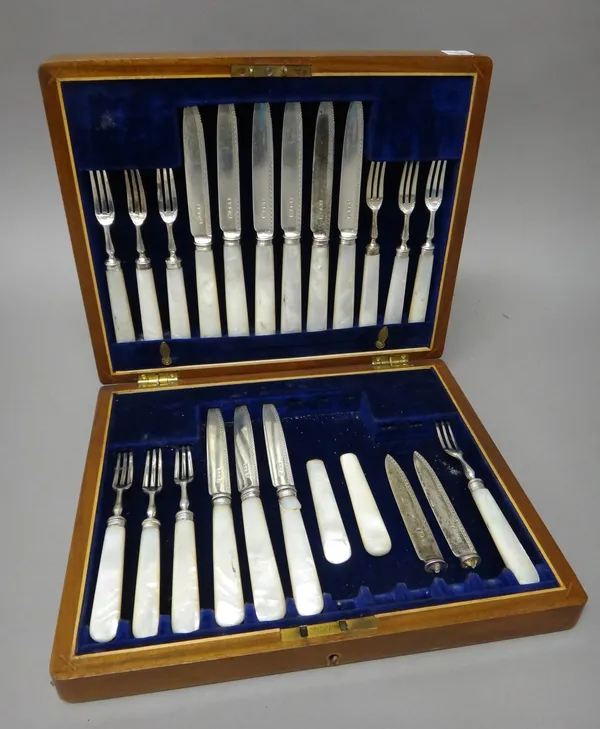 A part set of twenty-one dessert or fruit knives and forks, having mother-of-pearl handles, one fork Sheffield 1954, the rest Sheffield 1910, (three f