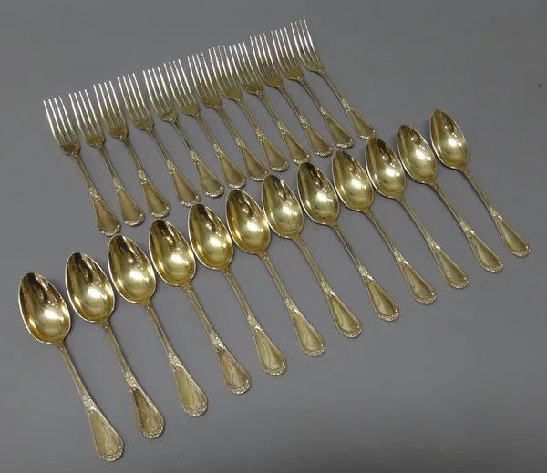 A French silver gilt part dessert service of flatware, comprising; twelve dessert spoons and twelve dessert forks, combined weight 1183 gms, (24).