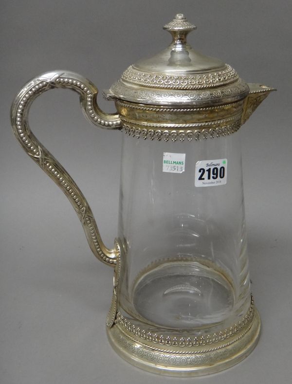 A silver mounted glass large claret jug, of tapering cylindrical form, the scrolled handle with beaded decoration, the top and bottom mounts with arca